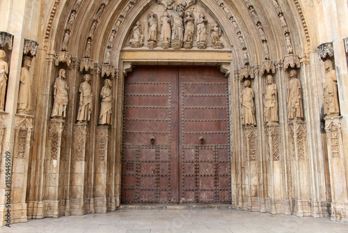 Entrance gate of Valencia Cathedral featuring historic Gothic stone architecture and religious details, taken in July 2024.