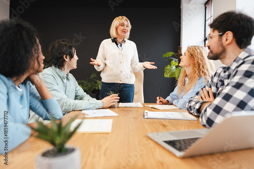 Εκτύπωση καμβά Smiling successful businesswoman leading team meeting in modern office, planning