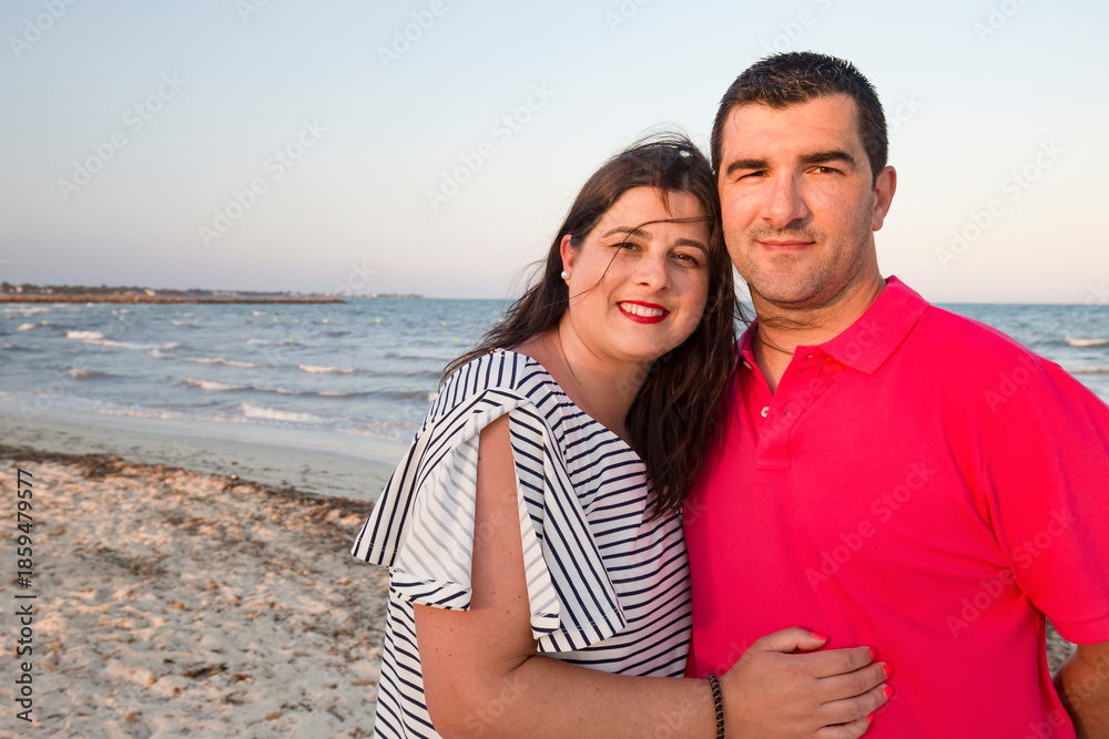 Fototapeta premium A middle-aged couple, looking happy, near the beach.