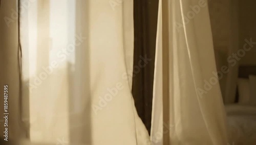 Gentle Breeze Through Sheer Curtains: Soft, flowing curtains gently billow in the sunlight, creating a tranquil atmosphere in this serene scene. Capturing the essence of calm and simplicity.