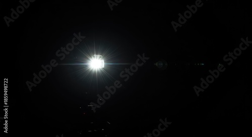 A camera flash illuminates a dark environment, momentarily capturing movement or a static scene with a burst of bright light ,low ,exposure ,equipment