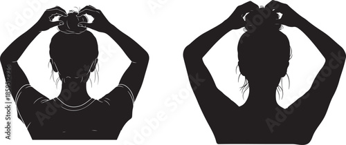 Woman styling her hair into a bun from behind