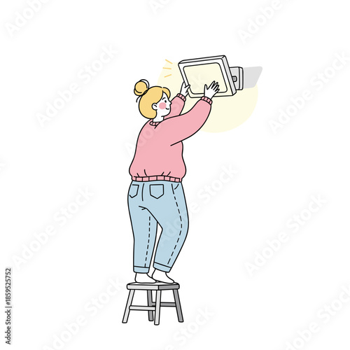 Plus-size woman adjusting a picture frame while standing on a stool  