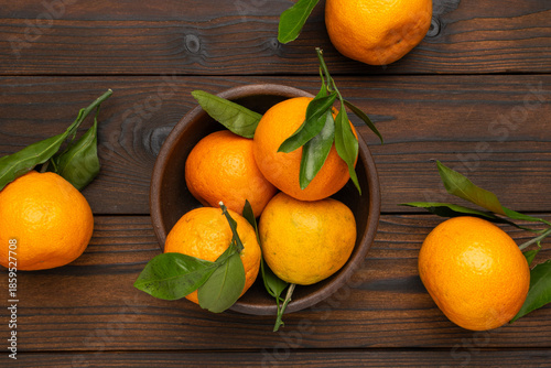 Wallpaper Mural Fresh Tangerines in a Rustic Wooden Bowl on a Dark Wood Table with Green Leaves Torontodigital.ca