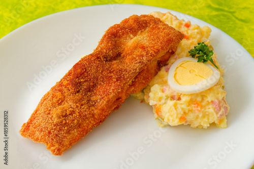 Traditional Czech Christmas fried carp with potato salad on plate