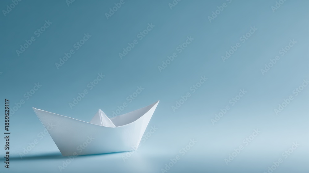 Obraz premium paper boat dreaming of vast skies, simple origami boat floating against clear blue background, ambition freedom and new beginnings concept