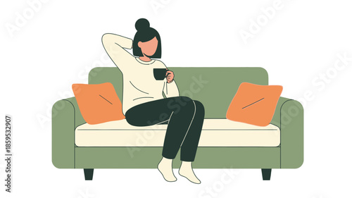 A woman relaxing on a green couch with orange pillows, holding a mug of coffee.