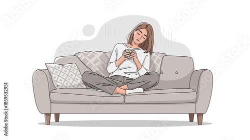 A young woman sitting comfortably on a sofa, holding a mug and relaxing indoors.