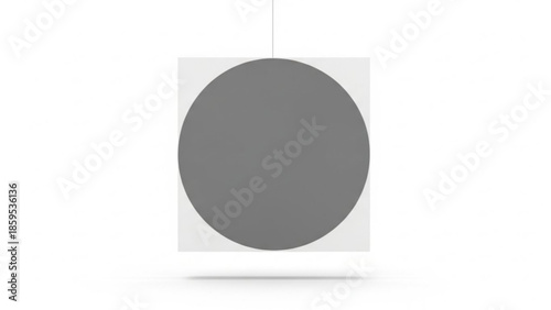 Grey circle shape hanging from a thin line on a white square background