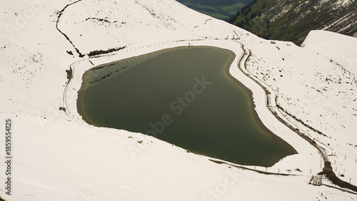 Another onset of winter in May, Riezler Alpsee, an artificially created lake, snow pond, feeds the snow cannons that completely snow the slopes of the Fellhorn and Kanzelwand cable cars, Allgäu Alps, Vorarlberg, Austria