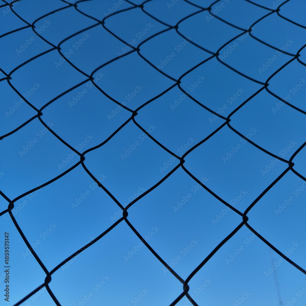 Fototapeta premium chain link fence with blue sky