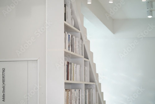 Minimalist White Bookshelf with Clean Lines and Neatly Arranged Books, Bright Interior Design Focused on Modern Aesthetics and Simplicity