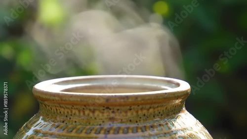 Steam Rising From A Clay Pot Outdoors.