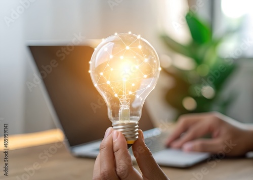 man holding light bulb in hand 