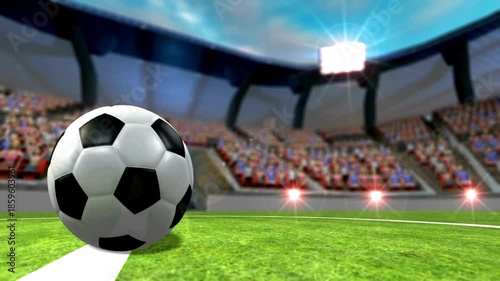 A soccer ball rests on a bright green pitch inside a packed stadium under bright lights. and cheers!