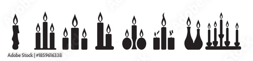 Variety of thick pillar candles grouped together on trays and decorative bases showing dripping wax effect