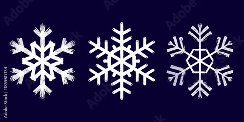Three delicate white snowflakes presented against a dark blue background