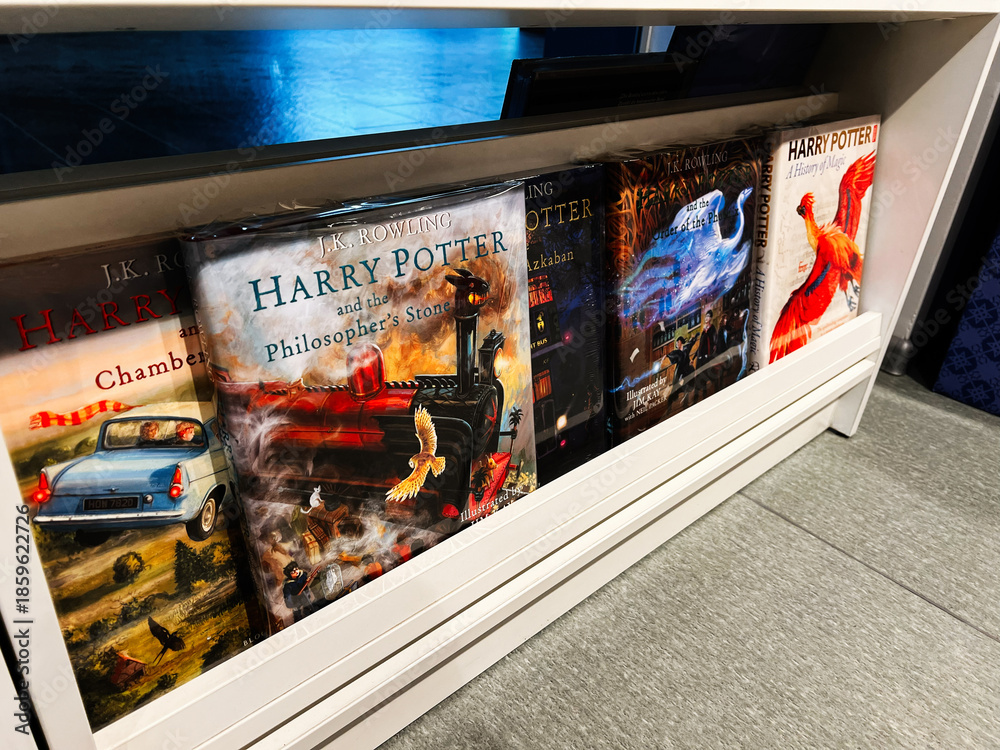 Naklejka premium Harry Potter and the Philosopher's Stone book collection on a shelf display with colorful covers