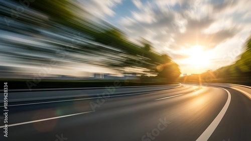 A speeding vehicle on a winding road at sunset with a blurred background and a clear highway ahead