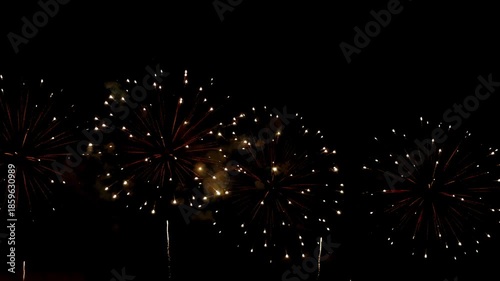 4K. loop seamless of real fireworks background golden shining fireworks with bokeh lights in the night sky. glowing fireworks show. New year's eve fireworks celebration multiple colors 