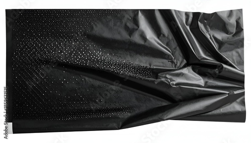 Black, creased, reflective material with a patterned section on white backdrop