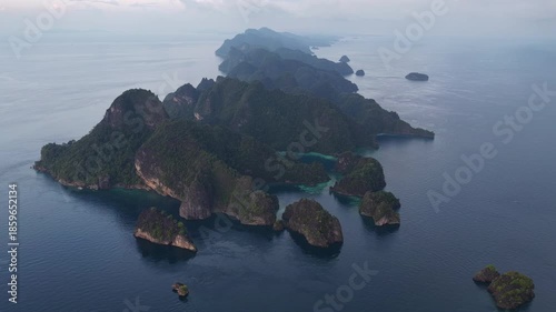 Rugged rock islands, composed of ancient, uplifted reefs, rise from the seascape in Misool, Indonesia. This region harbors spectacular marine biological diversity and is a popular destination for dive