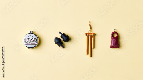 Artistic Still Life Arrangement of Small Decorative Items on a Pale Yellow Surface Showcasing Craftsmanship and Unique Design Aesthetics