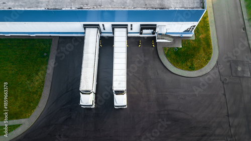 Bilde på lerret trucks are loaded in a modern logistics center. aerial view.