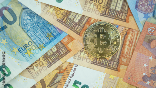 Bitcoin coin on euro banknotes background.