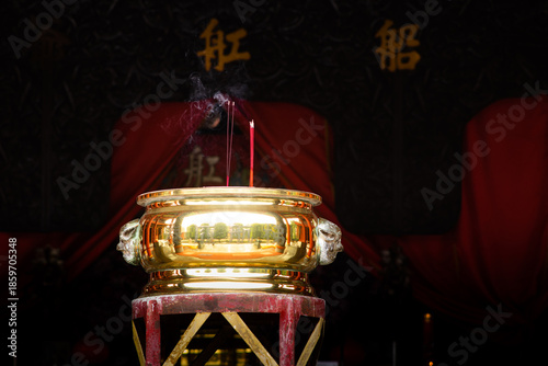 Burning Incense Sticks in a Golden Incense Burner Inside a Traditional Chinese Temple