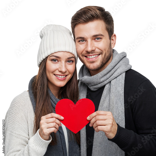 Happy couple in winter attire holding a red heart, symbolizing love and affection.