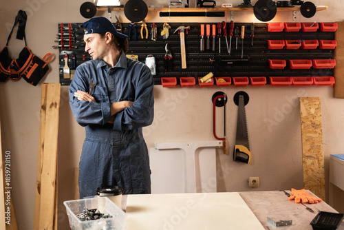 Canvas Print resentful woodwork man on furniture manufacturing or production with tools on the walls in workshop
