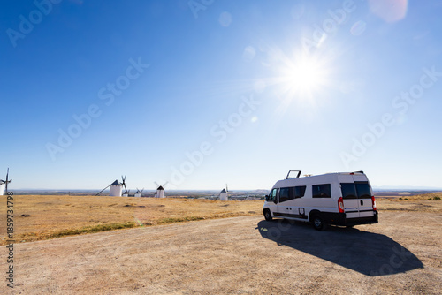 Camper van parked overlooking windmills in Campo de Criptana