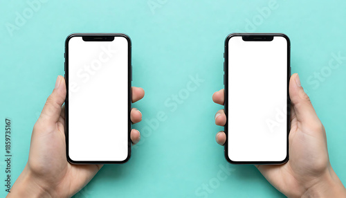 Two hands holding smartphones with blank white screens on a teal background