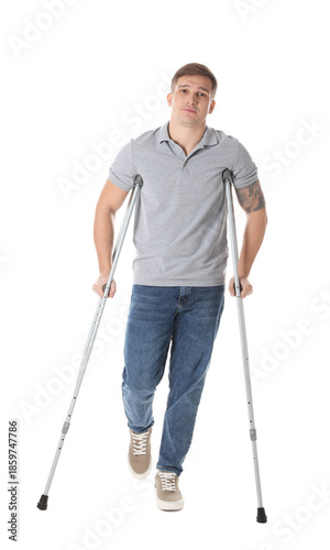 Man with axillary crutches on white background