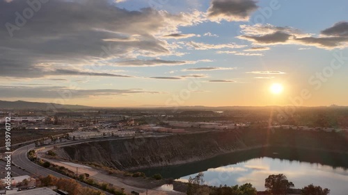 Aerial footage of a lake surrounded by homes and lush green trees at sunset in Duarte California USA