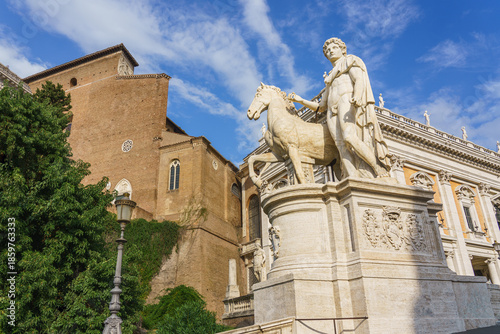 Statue of Emperor Augustus on Capitoline Hill in Rome, Italy, depicting the first Roman emperor in classical style with relief sculpture and historic architecture in the background.