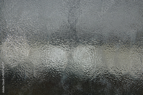 Photos background of intricate designs on a window, obscuring the outdoor view