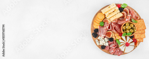 Canvas-taulu Top view of gourmet charcuterie board with cheese, prosciutto, olives, crackers