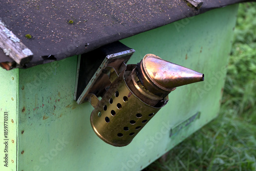 Beekeeping smoker tool on apiary, close-up