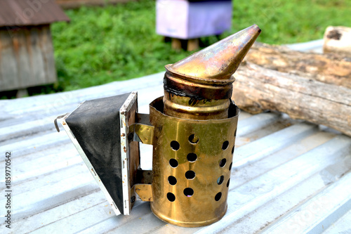 Beekeeping smoker tool on apiary, close-up