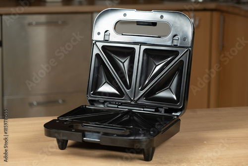 Tableau sur toile Open Electric Sandwich Toaster Appliance Ready to Use on a Wooden Kitchen Countertop