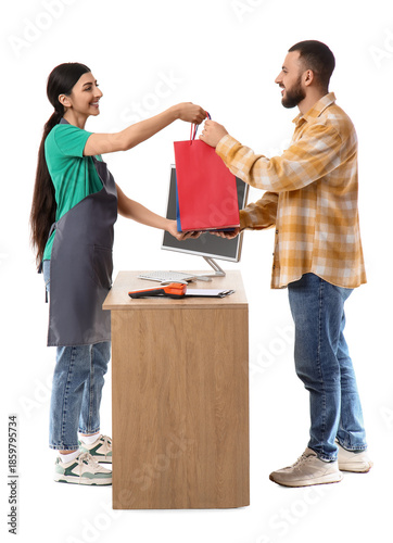 Female cashier giving bags ...