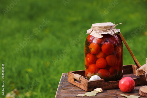 Jar of canned tomatoes with...