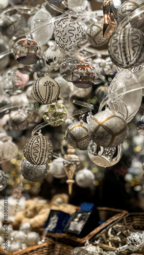 A close-up of a display case with Christmas tree decorations at a Christmas market
