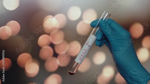 Gloved Hand Holding H3N2 Blood Sample for Virus Testing