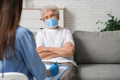 Elderly woman in medical ma...