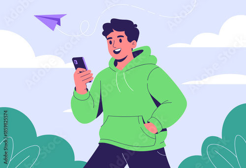 Cheerful Young Man in Green Hoodie Smiling at Smartphone with Paper Airplane in Bright Blue Sky