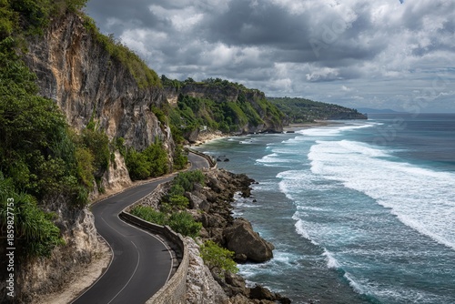 Wallpaper Mural Coastal landscape  winding asphalt road by limestone cliff with lush greenery and ocean vista Torontodigital.ca