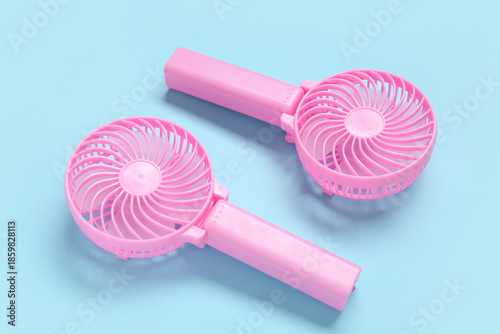 Small pink electric fans on...